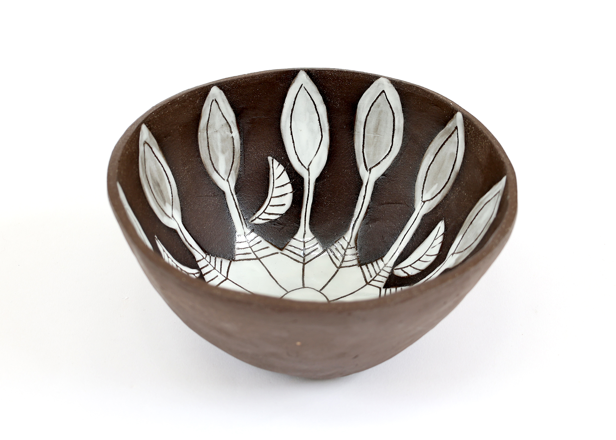 Ceramic bowl with dark brown exterior and white interior featuring elegant black leaf patterns in minimalist line work design